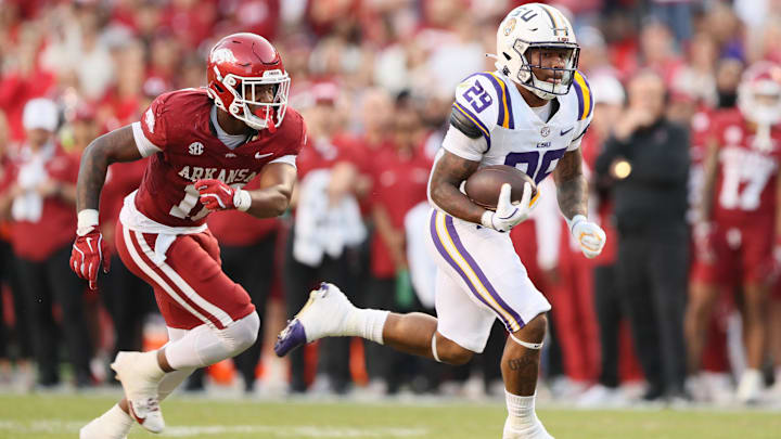 Oct 19, 2024; Fayetteville, Arkansas, USA; LSU Tigers running back Caden Durham (29) rushes for a touchdown against Arkansas Razorbacks linebacker Xavian Sorey Jr. (10) during the first quarter at Donald W. Reynolds Razorback Stadium. Mandatory Credit: Nelson Chenault-Imagn Images
