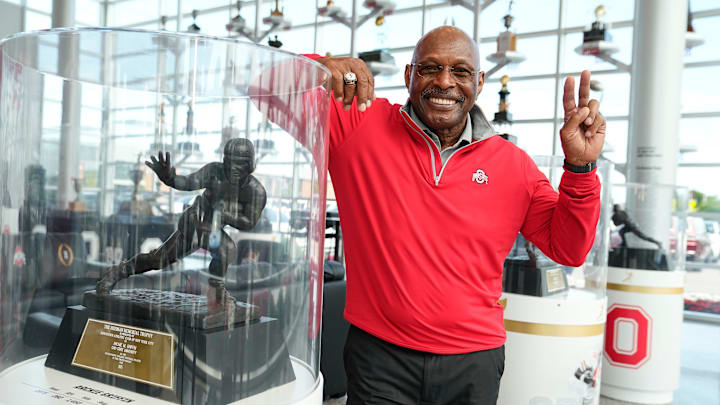 Jul 16, 2024; Columbus, OH, USA; Former Ohio State running back Archie Griffin stands with his two Heisman trophies inside the Woody Hayes Athletic Center. Griffin, who won the award in 1974 and 1975, is still the only two-time Heisman winner.