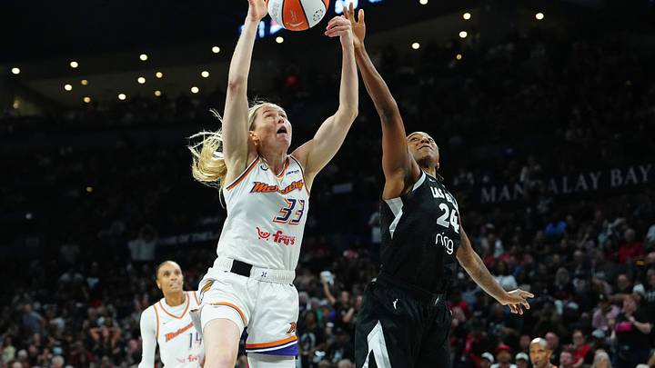 Oct 3, 2025; Las Vegas, Nevada, USA; Las Vegas Aces guard Jewell Loyd (24) looks to tip a loose ball away from Phoenix Mercury guard Sami Whitcomb (33) during the fourth quarter of game one of the 2025 WNBA Finals at Michelob Ultra Arena. Mandatory Credit: Stephen R. Sylvanie-Imagn Images
