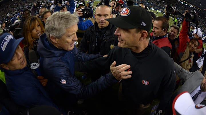 Seattle Seahawks coach Pete Carroll and San Francisco 49ers coach Jim Harbaugh shake hands after the 2013 NFC Championship football game at CenturyLink Field. 