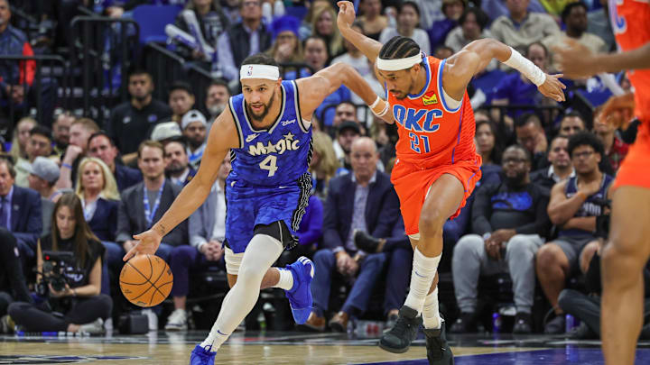 Orlando Magic guard Jalen Suggs (4) brings the ball up court against Oklahoma City Thunder guard Aaron Wiggins (21) during the second quarter at Amway Center. Orlando Magic guard Jalen Suggs (4) brings the ball up court against Oklahoma City Thunder guard Aaron Wiggins (21) during the second quarter at Amway Center.