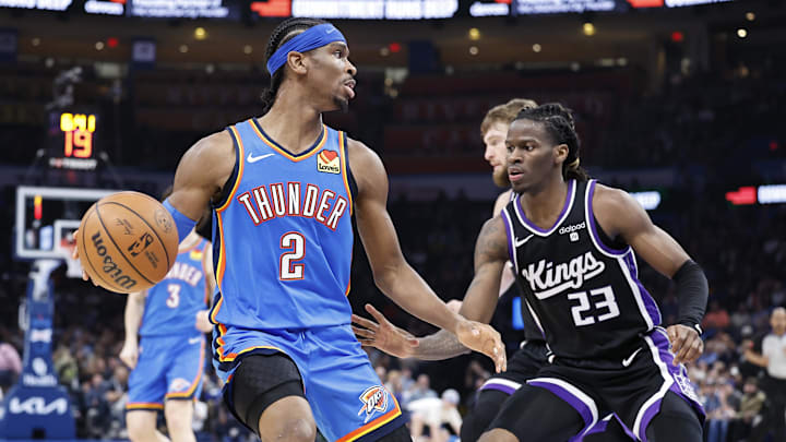 Apr 9, 2024; Oklahoma City, Oklahoma, USA; Oklahoma City Thunder guard Shai Gilgeous-Alexander (2) moves the ball against Sacramento Kings guard Keon Ellis (23) on a play during the second half at Paycom Center. Mandatory Credit: Alonzo Adams-Imagn Images