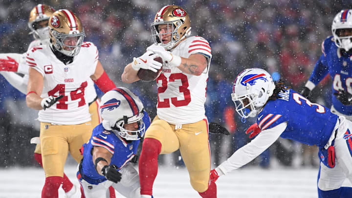 Dec 1, 2024; Orchard Park, New York, USA; San Francisco 49ers running back Christian McCaffrey (23) is tackled by Buffalo Bills safety Taylor Rapp (9) and safety Damar Hamlin (3) in the second quarter at Highmark Stadium. Mandatory Credit: Mark Konezny-Imagn Images