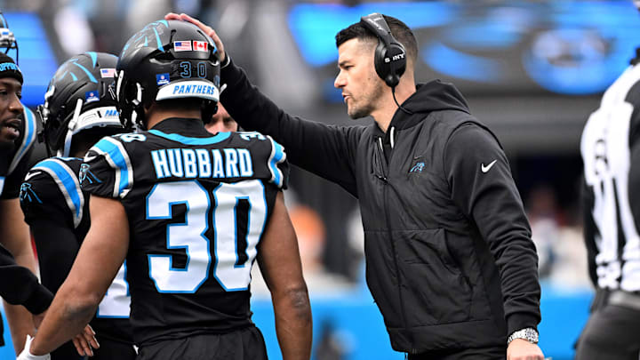 Dec 21, 2025; Charlotte, North Carolina, USA; Carolina Panthers head coach Dave Canales with running back Chuba Hubbard (30) in the third quarter at Bank of America Stadium. Mandatory Credit: Bob Donnan-Imagn Images