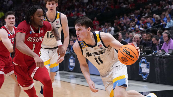 Marquette guard Tyler Kolek (11) turns the corner on North Carolina State guard Jayden Taylor (1) during the first half of their game in the semifinals of the South Regional of the 2024 NCAA Men's Basketball Tournament Friday at American Airlines Arena in Dallas.