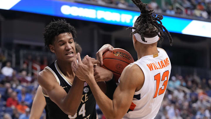 Mar 8, 2023; Greensboro, NC, USA; Syracuse Orange forward Benny Williams (13) and Wake Forest Demon Deacons forward Bobi Klintman (34) right for the ball in the second half of the second round at Greensboro Coliseum. Mandatory Credit: Bob Donnan-Imagn Images