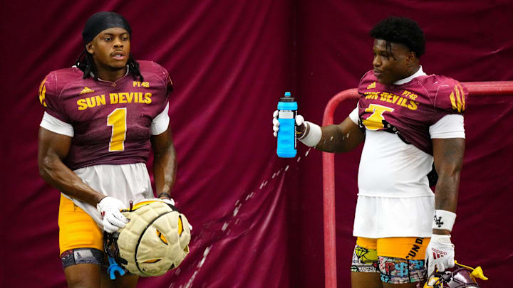 Arizona State running backs Kyson Brown (1) and Raleek Brown (3) take a water break during a practice inside the Verde Dickey Dome in Tempe on August 12, 2025.