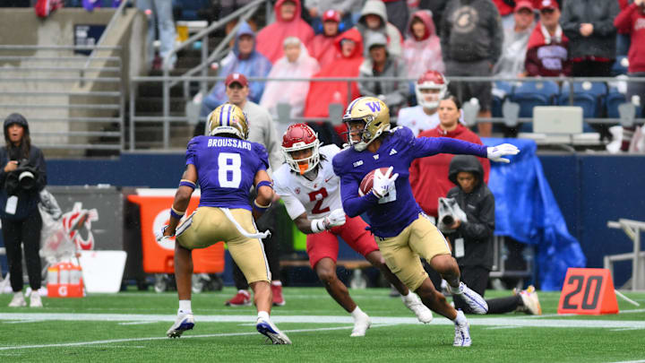 Sep 14, 2024; Seattle, Washington, USA; Washington Huskies cornerback Thaddeus Dixon (9) carries the ball after intercepting a pass against the Washington State Cougars during the second half at Lumen Field. Mandatory Credit: Steven Bisig-Imagn Images
