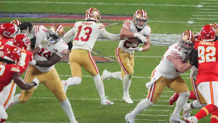 Feb 11, 2024; Paradise, Nevada, USA;  San Francisco 49ers quarterback Brock Purdy (13) hands the ball to running back Christian McCaffrey (23) against the Kansas City Chiefs during overtime of Super Bowl LVIII at Allegiant Stadium. Mandatory Credit: Joe Camporeale-USA TODAY Sports