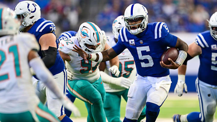 Oct 20, 2024; Indianapolis, Indiana, USA; Indianapolis Colts quarterback Anthony Richardson (5) runs the ball past Miami Dolphins defensive tackle Zach Sieler (92) during the second half at Lucas Oil Stadium. Mandatory Credit: Marc Lebryk-Imagn Images