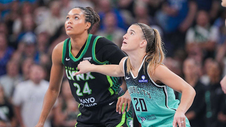 Jul 30, 2025; Minneapolis, Minnesota, USA; New York Liberty guard Sabrina Ionescu (20) and Minnesota Lynx forward Napheesa Collier (24) in the first quarter at Target Center. Mandatory Credit: Brad Rempel-Imagn Images