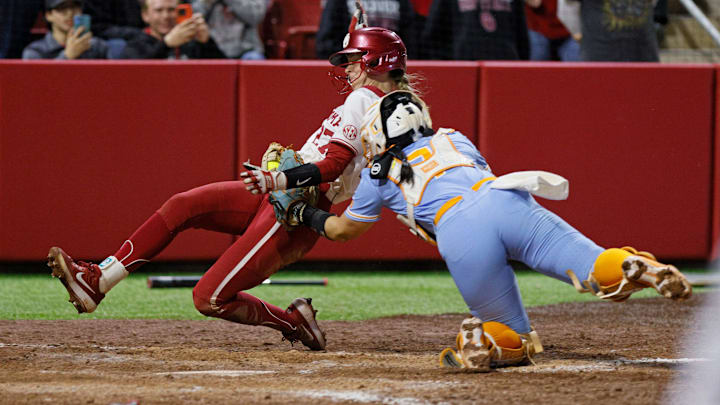 Oklahoma's Hannah Coor is tagged out at home by Tennessee catcher Sophia Nugent. Oklahoma's Hannah Coor is tagged out at home by Tennessee catcher Sophia Nugent.