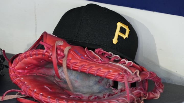 Jun 23, 2025; Milwaukee, Wisconsin, USA; against the Pittsburgh Pirates hat and glove in the dugout before a game against the Milwaukee Brewers at American Family Field. Mandatory Credit: Michael McLoone-Imagn Images