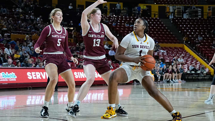 Kadidia Toure (1) of the ASU Sun Devils look to shoot, guarded by Olivia Pollerd (5) and Lara Edmanson (13) of the SCU Broncos as Santa Clara University plays Arizona State University at Desert Financial Arena on Dec. 30, 2023, in Tempe.