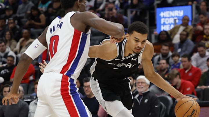   San Antonio Spurs center Victor Wembanyama (1) dribbles defended by Detroit Pistons center Jalen Duren (0) in the second half at Little Caesars Arena. Mandatory Credit: Rick Osentoski-Imagn Images