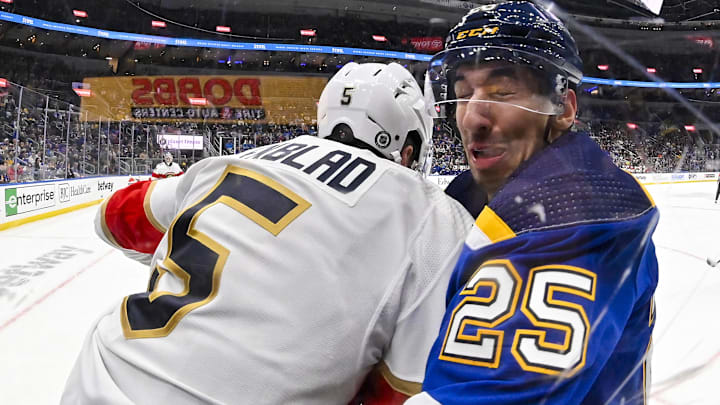 Jan 9, 2024; St. Louis, Missouri, USA;  Florida Panthers defenseman Aaron Ekblad (5) checks St. Louis Blues center Jordan Kyrou (25) during the second period at Enterprise Center. Mandatory Credit: Jeff Curry-Imagn Images