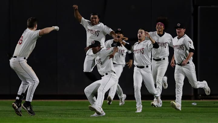 Wisconsin Timber Rattlers' Luke Adams (28) celebrates with teammates after hitting a game-winning single to right field against the Quad Cities River Bandits during their Midwest League playoff baseball game Thursday, September 12, 2024, at Neuroscience Group Field at Fox Cities Stadium in Grand Chute, Wisconsin., Wisconsin. The Rattlers won 7-6 and move on to face Lake County in the Midwest League Championship Series starting Sunday.