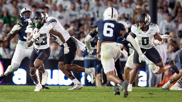 Oregon running back Dierre Hill Jr., left, carries the ball as Oregon running back Jordon Davison, right, runs as the Oregon Ducks face the Penn State Nittany Lions on Sept. 27, 2025, at Beaver Stadium in University Park, Pennsylvania.