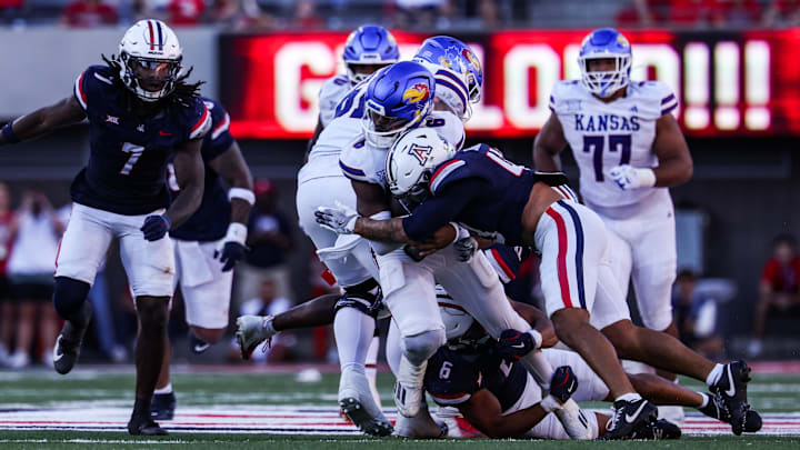 Nov 8, 2025; Tucson, Arizona, USA; Kansas Jayhawks quarterback Jalon Daniels (6) gets tackled by the Arizona Wildcats during the fourth quarter of the game at Arizona Stadium. Mandatory Credit: Aryanna Frank-Imagn Images
