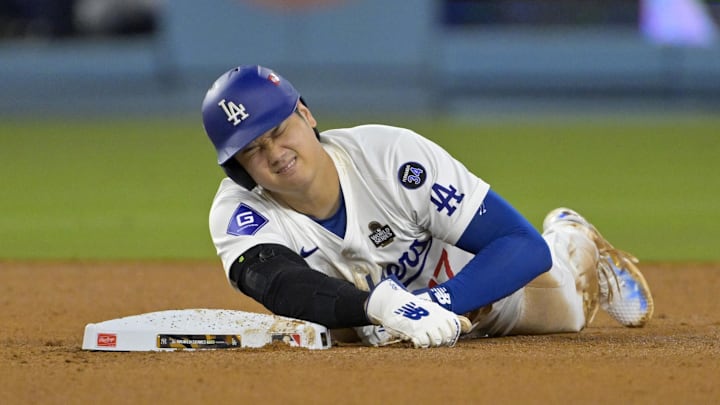 Oct 26, 2024; Los Angeles, California, USA; Los Angeles Dodgers designated hitter Shohei Ohtani (17) reacts at second base after an apparent injury in the seventh inning against the New York Yankees during game two of the 2024 MLB World Series at Dodger Stadium. Mandatory Credit: Jayne Kamin-Oncea-Imagn Images