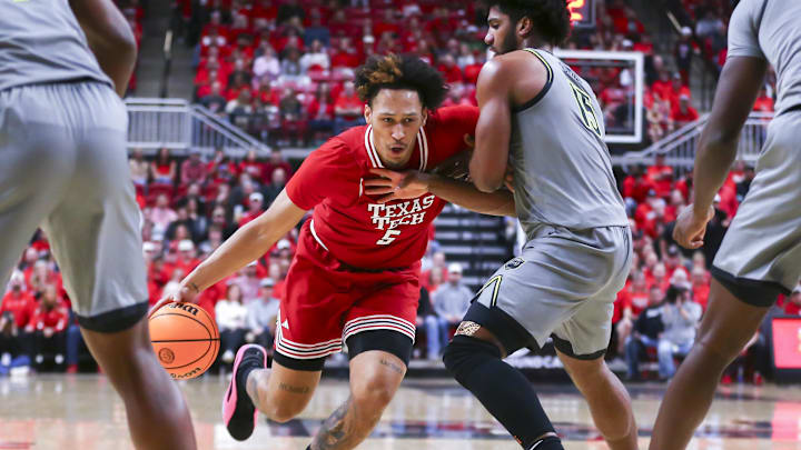 Feb 4, 2025; Lubbock, Texas, USA;  Texas Tech Red Raiders forward Darrion Williams (5) drives the ball against Baylor Bears forward Norchad Omier (15)  in the second half at United Supermarkets Arena. Mandatory Credit: Michael C. Johnson-Imagn Images