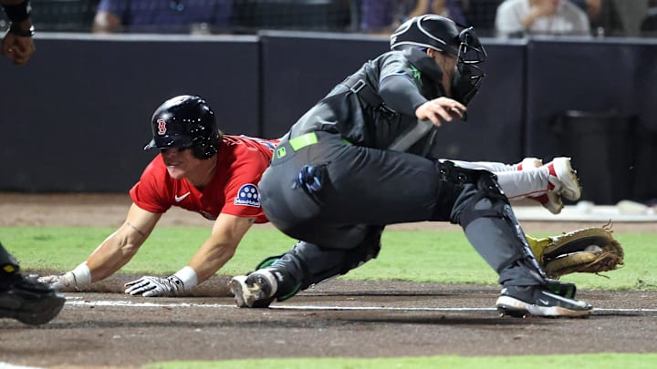 Sep 19, 2025; Tampa, Florida, USA; Boston Red Sox outfielder Nate Eaton (40) slides into home plate as Tampa Bay Rays catcher Nick Fortes (40) attempts to tag him out during the second inning  at George M. Steinbrenner Field. Mandatory Credit: Kim Klement Neitzel-Imagn Images