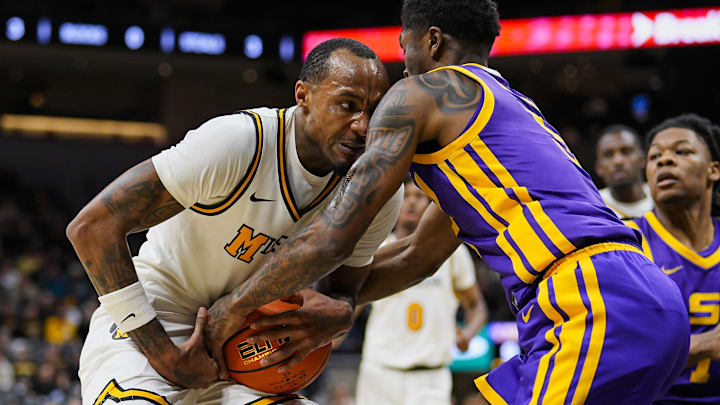 Jan 7, 2025; Columbia, Missouri, USA; LSU Tigers guard Cam Carter (5) steals the ball from Missouri Tigers guard Tamar Bates (2) during the first half at Mizzou Arena. Mandatory Credit: Jay Biggerstaff-Imagn Images Jan 7, 2025; Columbia, Missouri, USA; LSU Tigers guard Cam Carter (5) steals the ball from Missouri Tigers guard Tamar Bates (2) during the first half at Mizzou Arena. Mandatory Credit: Jay Biggerstaff-Imagn Images