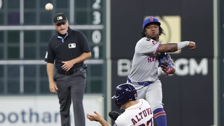 Mar 27, 2025; Houston, Texas, USA; New York Mets second baseman Luisangel Acuna (2) forces out Houston Astros left fielder Jose Altuve (27) at second base and turns a double play in the fourth inning at Daikin Park. Mandatory Credit: Thomas Shea-Imagn Images