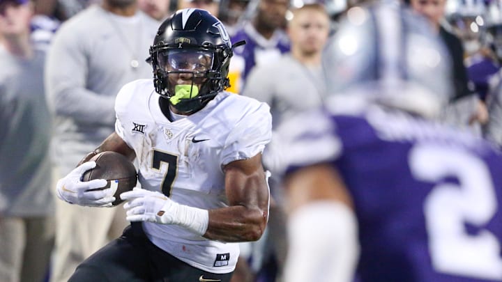 Sep 23, 2023; Manhattan, Kansas, USA; UCF Knights running back RJ Harvey (7) looks for room to run during the first quarter against the Kansas State Wildcats at Bill Snyder Family Football Stadium. 