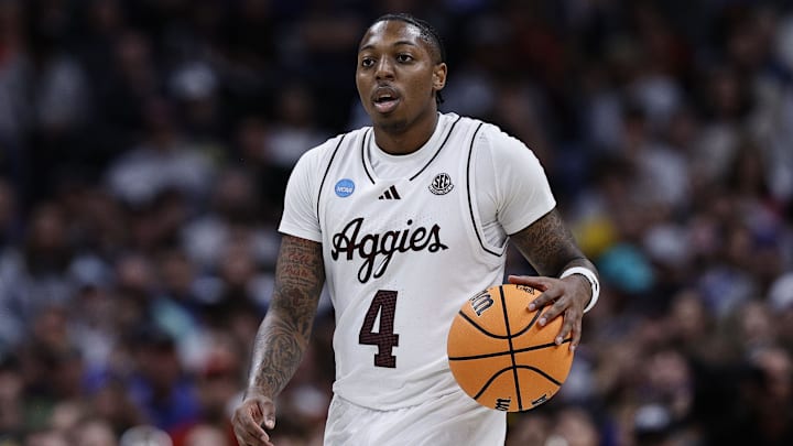 Mar 22, 2025; Denver, CO, USA; Texas A&M Aggies guard Wade Taylor IV (4) dribbles the ball against the Michigan Wolverines during the second half in the second round of the NCAA Tournament  at Ball Arena. Mandatory Credit: Isaiah J. Downing-Imagn Images