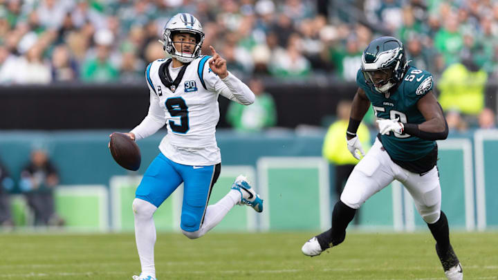 Dec 8, 2024; Philadelphia, Pennsylvania, USA;  Carolina Panthers quarterback Bryce Young (9) runs with the ball past Philadelphia Eagles linebacker Jalyx Hunt (58) during the second quarter at Lincoln Financial Field. Mandatory Credit: Bill Streicher-Imagn Images