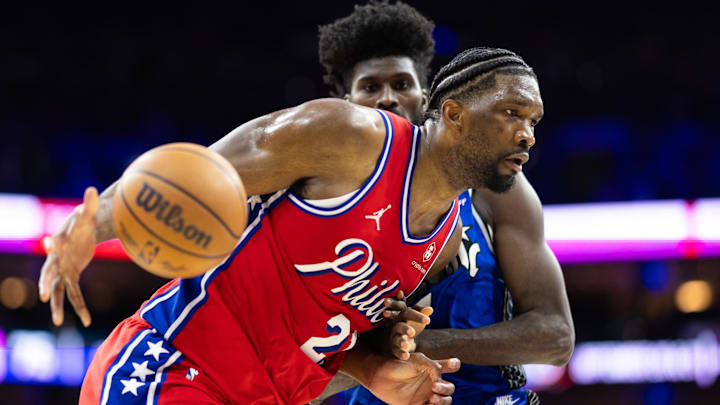 Apr 12, 2024; Philadelphia, Pennsylvania, USA; Philadelphia 76ers center Joel Embiid (21) drives against Orlando Magic forward Jonathan Isaac (1) during the third quarter at Wells Fargo Center. Mandatory Credit: Bill Streicher-Imagn Images