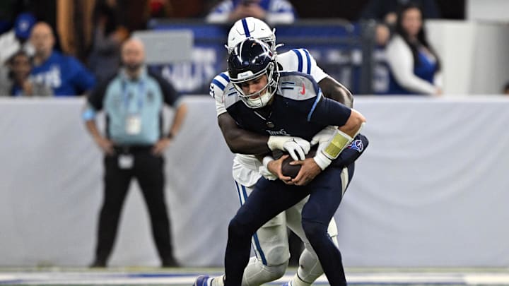 Dec 22, 2024; Indianapolis, Indiana, USA; Indianapolis Colts defensive end Kwity Paye (51) sacks Tennessee Titans quarterback Mason Rudolph (11) during the second half at Lucas Oil Stadium. Mandatory Credit: Marc Lebryk-Imagn Images
