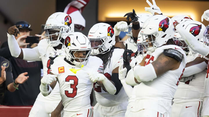Dec 15, 2024; Glendale, Arizona, USA; Arizona Cardinals safety Budda Baker (3) celebrates a turnover with teammates against the New England Patriots at State Farm Stadium. Mandatory Credit: Mark J. Rebilas-Imagn Images
