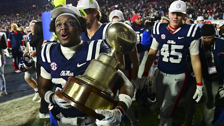 Mississippi Rebels players react with the Egg Bowl trophy after the game against the Mississippi State Bulldogs at Vaught-Hemingway Stadium. Mississippi Rebels players react with the Egg Bowl trophy after the game against the Mississippi State Bulldogs at Vaught-Hemingway Stadium.