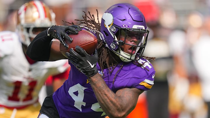 Sep 15, 2024; Minneapolis, Minnesota, USA; Minnesota Vikings safety Josh Metellus (44) intercepts the ball against the San Francisco 49ers in the third quarter at U.S. Bank Stadium. Mandatory Credit: Brad Rempel-Imagn Images