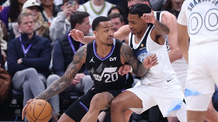 Feb 28, 2025; Salt Lake City, Utah, USA; Utah Jazz forward John Collins (20) dribbles the ball against Minnesota Timberwolves guard Rob Dillingham during the second half at Delta Center. Mandatory Credit: Rob Gray-Imagn Images