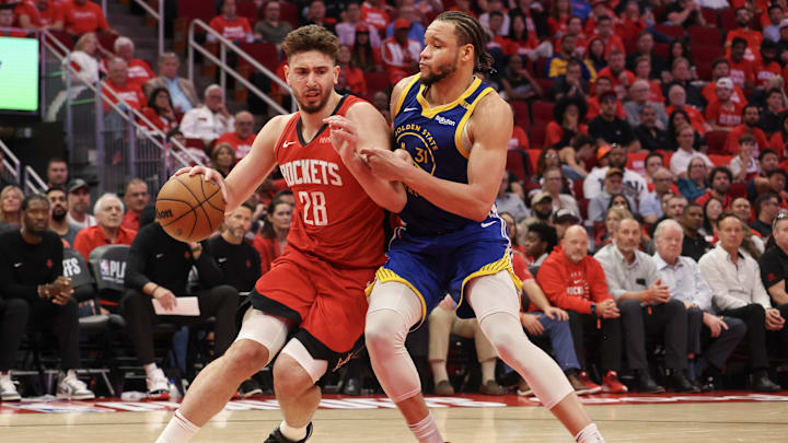 Apr 30, 2025; Houston, Texas, USA; Houston Rockets center Alperen Sengun (28) dribbles against Golden State Warriors forward Kevin Knox II (31) in the fourth quarter during game five of first round for the 2025 NBA Playoffs at Toyota Center. Mandatory Credit: Thomas Shea-Imagn Images