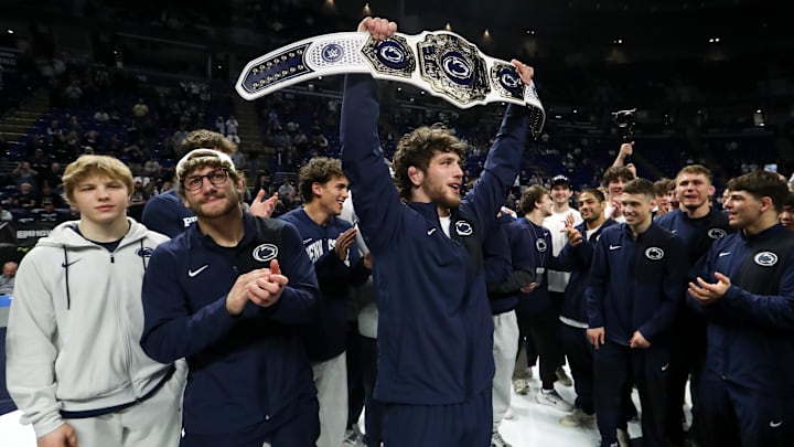 Penn State Nittany Lions wrestler Levi Haines raises the championship belt after winning the team title at the Big Ten Wrestling Championships at Bryce Jordan Center. 