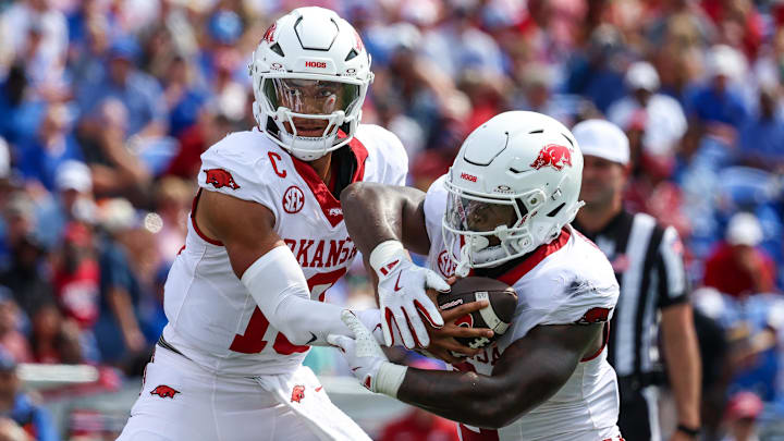 Arkansas Razorbacks quarterback Taylen Green (10) hands the ball to running back Braylen Russell (0) during the first half against the Memphis Tigers at Simmons Bank Liberty Stadium. Arkansas Razorbacks quarterback Taylen Green (10) hands the ball to running back Braylen Russell (0) during the first half against the Memphis Tigers at Simmons Bank Liberty Stadium.