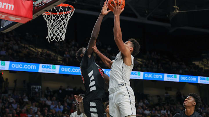 Feb 5, 2025; Orlando, Florida, USA; UCF Knights guard Keyshawn Hall (4) goes to the basket against Cincinnati Bearcats forward Aziz Bandaogo (55) during the second half at Addition Financial Arena. Mandatory Credit: Mike Watters-Imagn Images Feb 5, 2025; Orlando, Florida, USA; UCF Knights guard Keyshawn Hall (4) goes to the basket against Cincinnati Bearcats forward Aziz Bandaogo (55) during the second half at Addition Financial Arena. Mandatory Credit: Mike Watters-Imagn Images