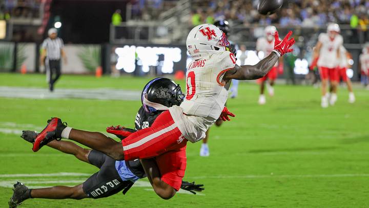 Nov 7, 2025; Orlando, Florida, USA; Houston Cougars wide receiver Amare Thomas (0) dives to catch a pass against UCF Knights defensive back DJ Bell (5) during the first quarter at Acrisure Bounce House. Mandatory Credit: Mike Watters-Imagn Images Nov 7, 2025; Orlando, Florida, USA; Houston Cougars wide receiver Amare Thomas (0) dives to catch a pass against UCF Knights defensive back DJ Bell (5) during the first quarter at Acrisure Bounce House. Mandatory Credit: Mike Watters-Imagn Images