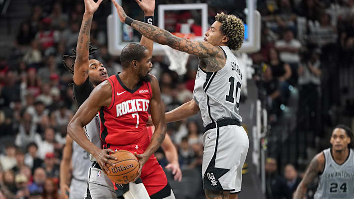 Nov 7, 2025; San Antonio, Texas, USA; San Antonio Spurs guard Stephon Castle (5) and forward Jeremy Sochan (10) guard Houston Rockets forward Kevin Durant (7) during the second half at Frost Bank Center. Mandatory Credit: Dustin Safranek-Imagn Images