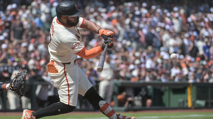 Jun 7, 2025; San Francisco, California, USA; San Francisco Giants outfielder Heliot Ramos (17) hits a single against the Atlanta Braves during the ninth inning at Oracle Park.