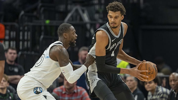 San Antonio Spurs center Victor Wembanyama backs towards the basket against Minnesota Timberwolves forward Julius Randle in the first half at Target Center in Minneapolis on Dec. 29, 2024. San Antonio Spurs center Victor Wembanyama backs towards the basket against Minnesota Timberwolves forward Julius Randle in the first half at Target Center in Minneapolis on Dec. 29, 2024.