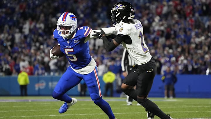 Buffalo Bills wide receiver Joshua Palmer runs the ball against Baltimore Ravens cornerback Nate Wiggins.