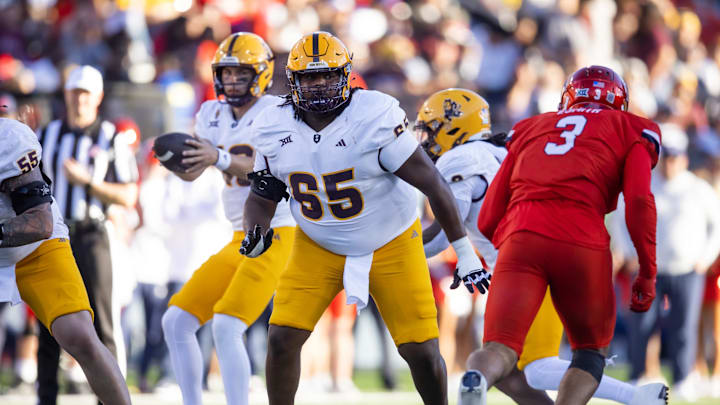 Nov 30, 2024; Tucson, Arizona, USA; Arizona State Sun Devils offensive lineman Josh Atkins (65) against the Arizona Wildcats during the Territorial Cup at Arizona Stadium. Mandatory Credit: Mark J. Rebilas-Imagn Images Nov 30, 2024; Tucson, Arizona, USA; Arizona State Sun Devils offensive lineman Josh Atkins (65) against the Arizona Wildcats during the Territorial Cup at Arizona Stadium. Mandatory Credit: Mark J. Rebilas-Imagn Images