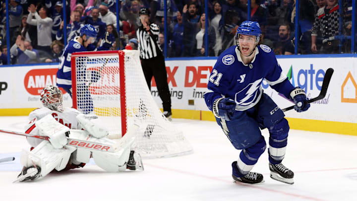 Jan 7, 2025; Tampa, Florida, USA;Tampa Bay Lightning center Brayden Point (21) celebrates after he scored the game winning goal on Carolina Hurricanes goaltender Pyotr Kochetkov (52)  during the third period at Amalie Arena. Mandatory Credit: Kim Klement Neitzel-Imagn Images