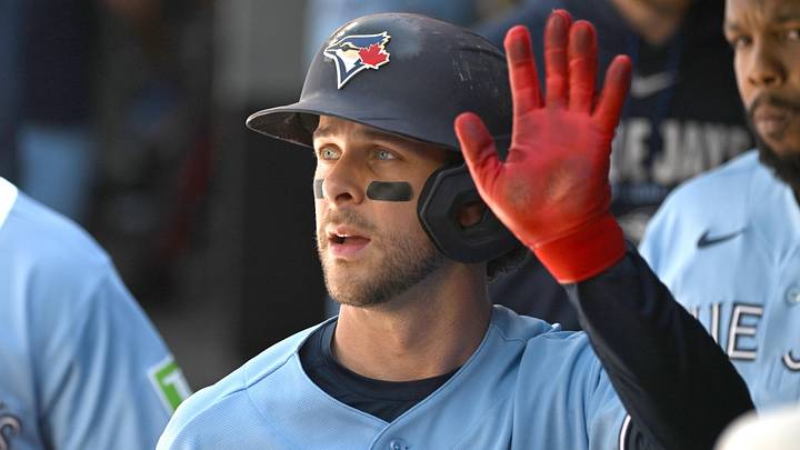 Jun 6, 2026; Toronto, Ontario, CAN;  Toronto Blue Jays second baseman Ernie Clement (22) celebrates in the dugout with teammates after scoring a run against the Baltimore Orioles in the second inning at Rogers Centre. 