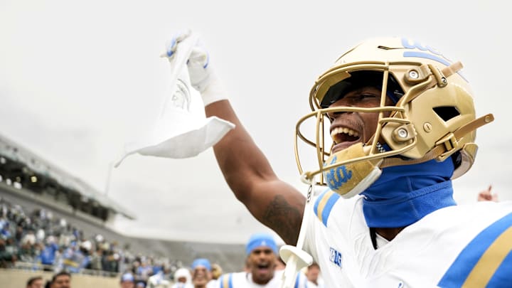 Oct 11, 2025; East Lansing, Michigan, USA; UCLA Bruins defensive back Key Lawrence (4) holds up a towel branding the Michigan State logo after beating the Spartans at Spartan Stadium. Mandatory Credit: Brendan Mullin-Imagn Images Oct 11, 2025; East Lansing, Michigan, USA; UCLA Bruins defensive back Key Lawrence (4) holds up a towel branding the Michigan State logo after beating the Spartans at Spartan Stadium. Mandatory Credit: Brendan Mullin-Imagn Images